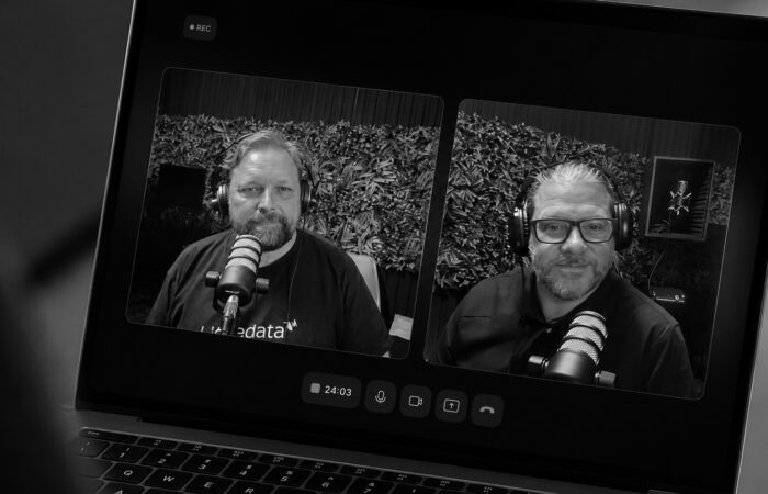 Men on laptop screen recording a podcast